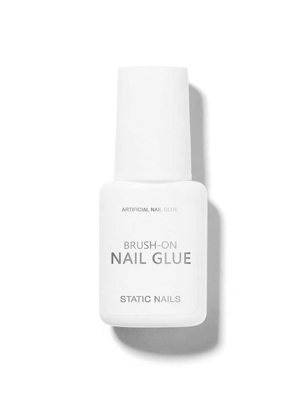 White brush-on nail glue bottle,  