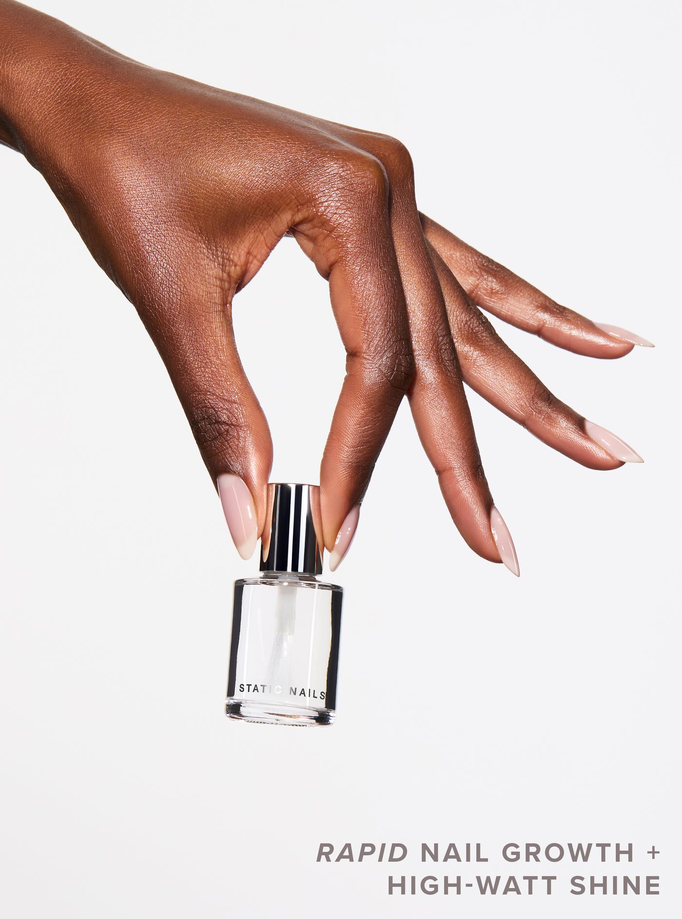 Hand holding a nail polish bottle with text about nail growth and shine on a white background