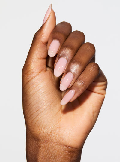 SIGNATURE PINK 5-IN-1 RAPID GROWTH NAIL TREATMENTHand with pink nail polish on a pink background