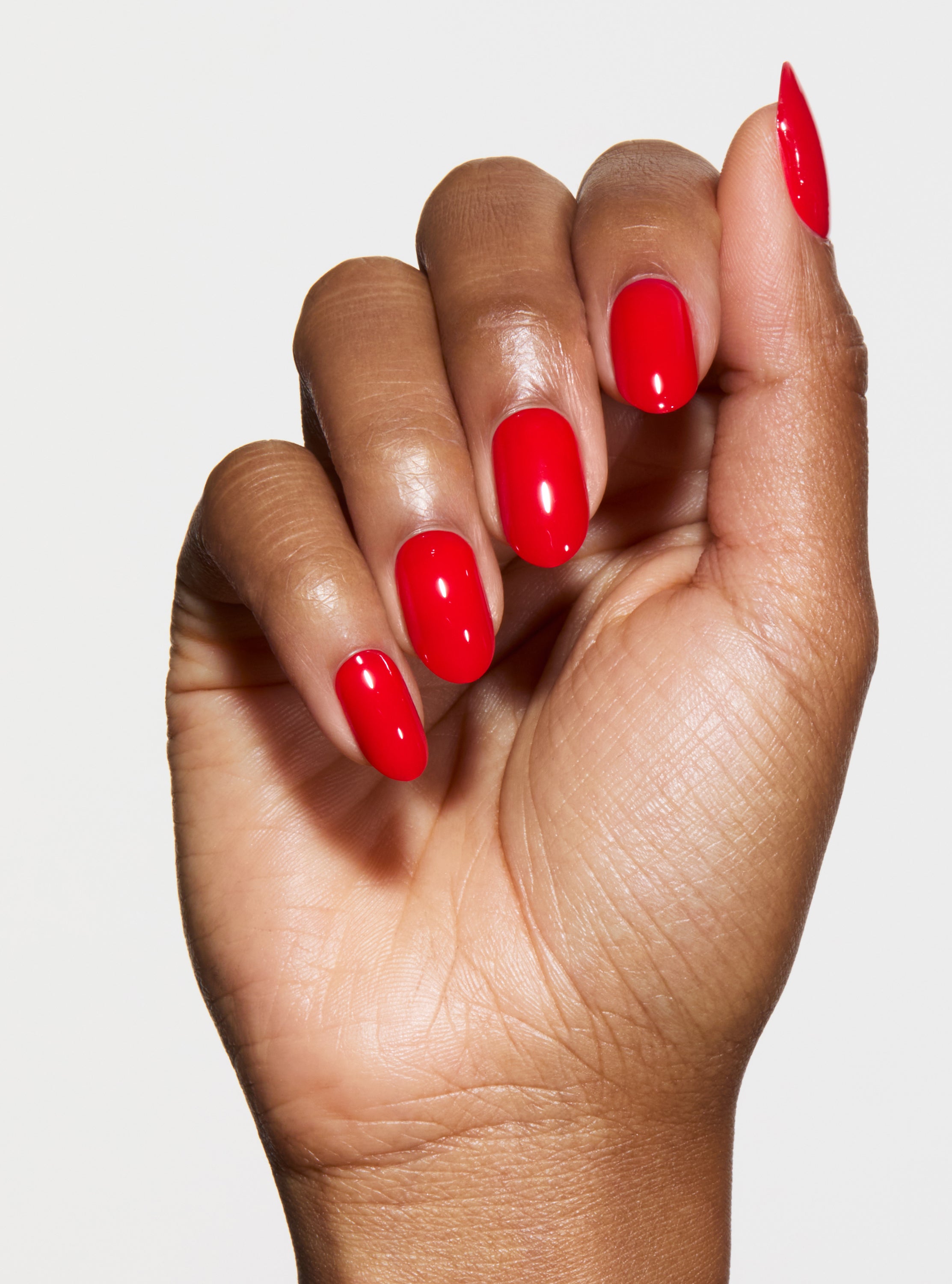 bright red nails on darker hand