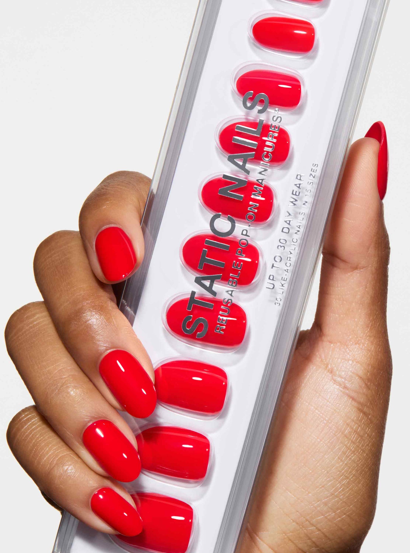 bright red nails on darker hand