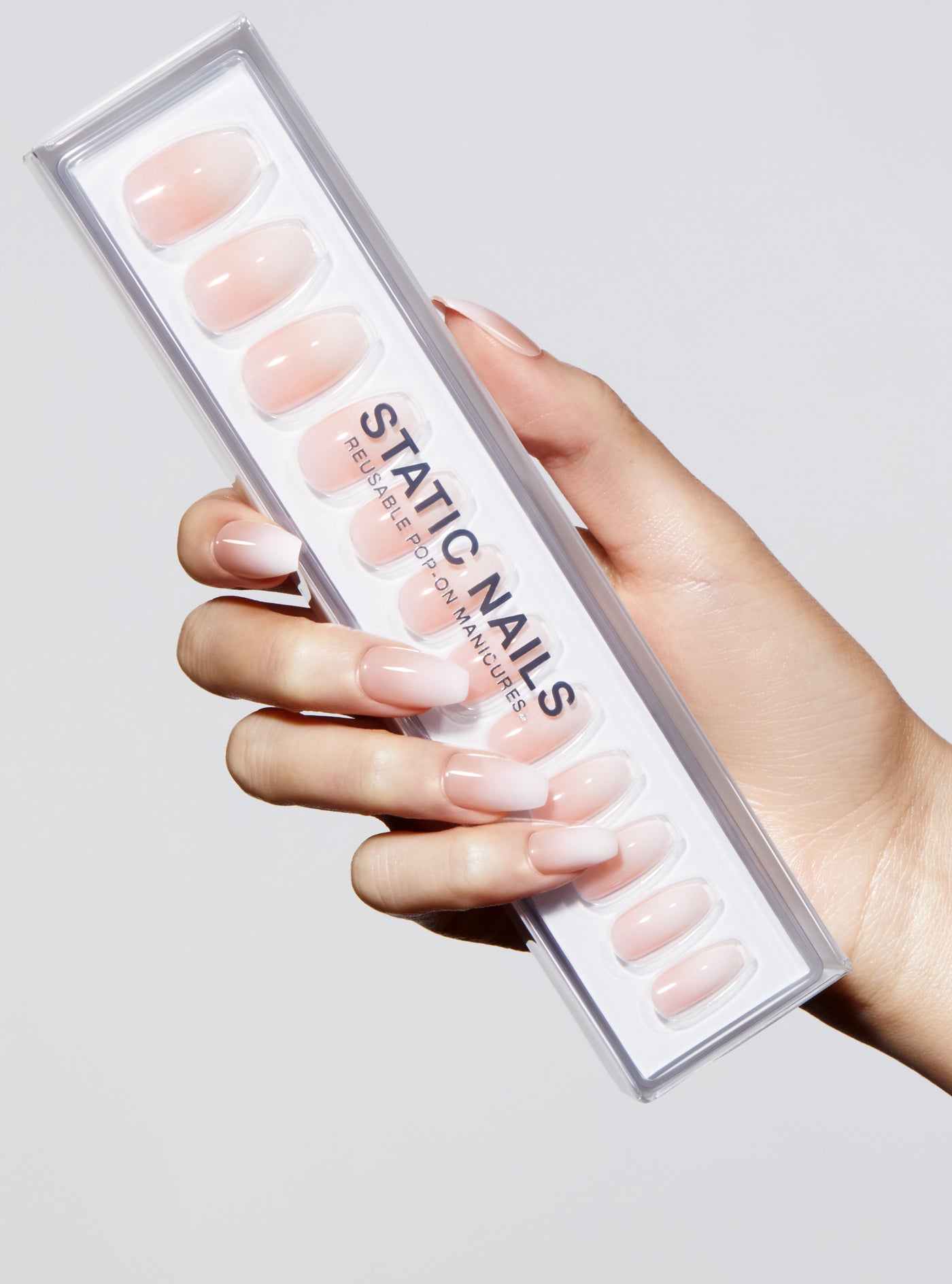 Ombre light pink to white manicure in coffin shape,