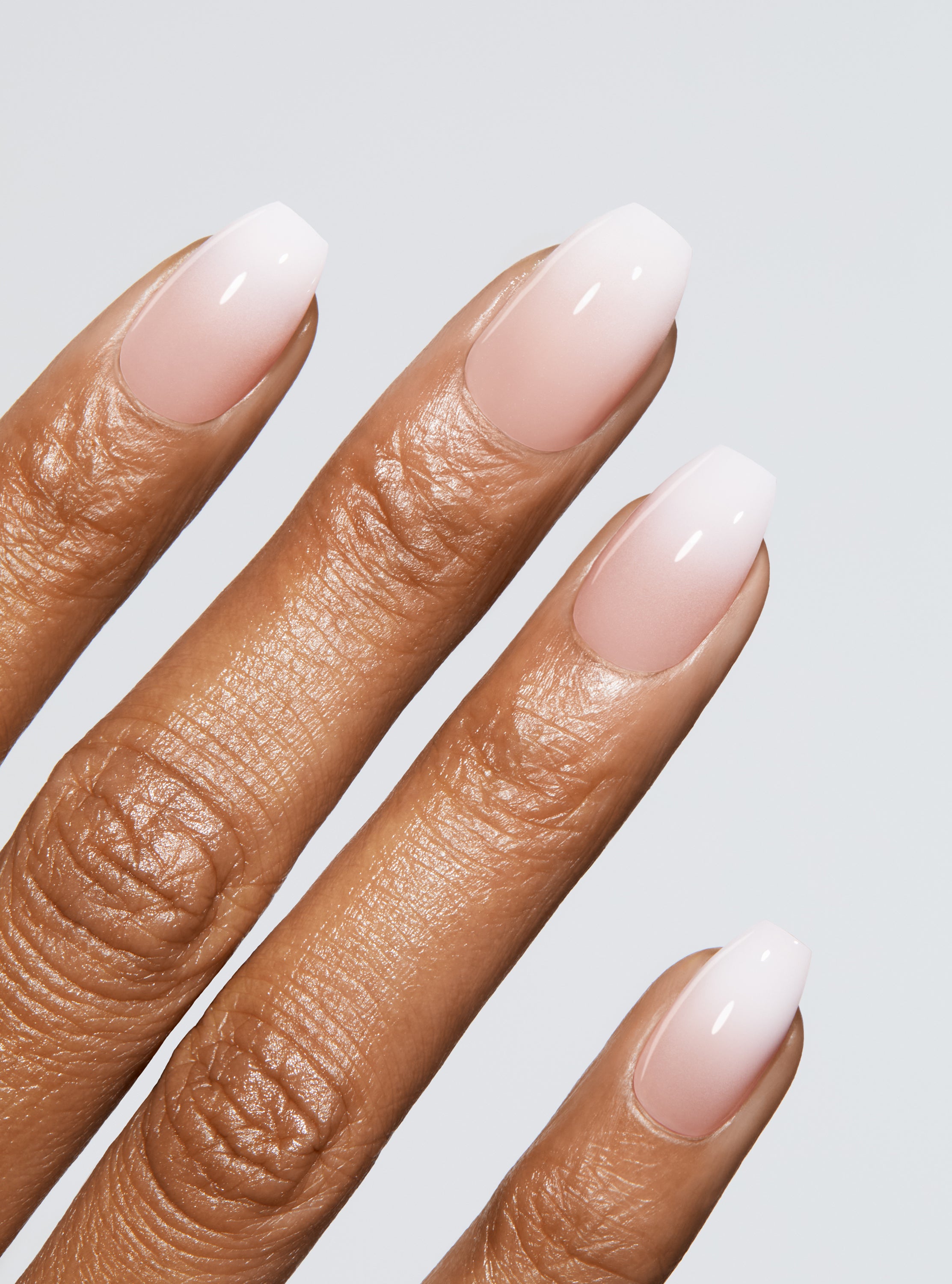 Ombre light pink to white manicure in coffin shape,