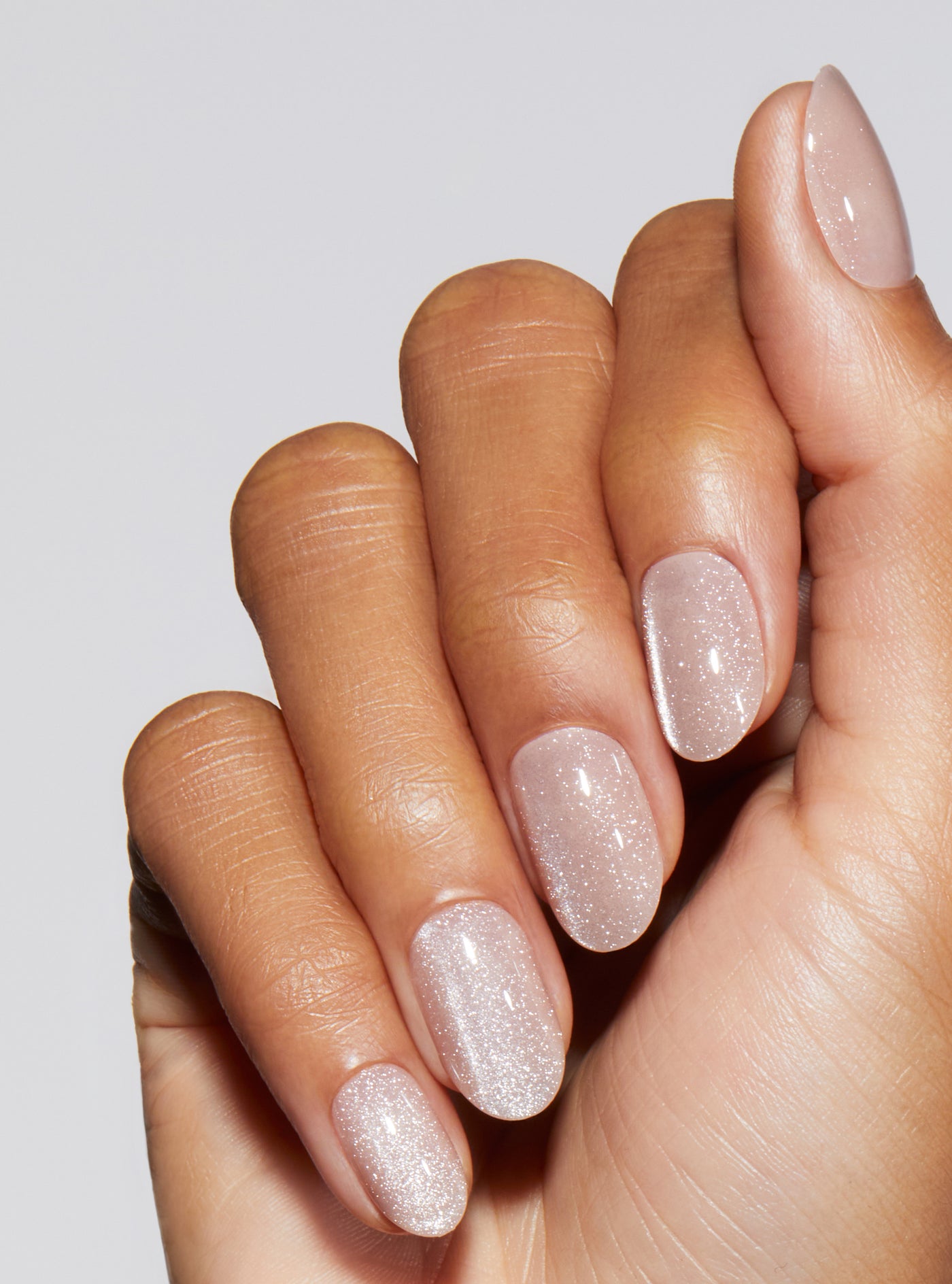 Nude manicure with cat-eye effect in round shape,