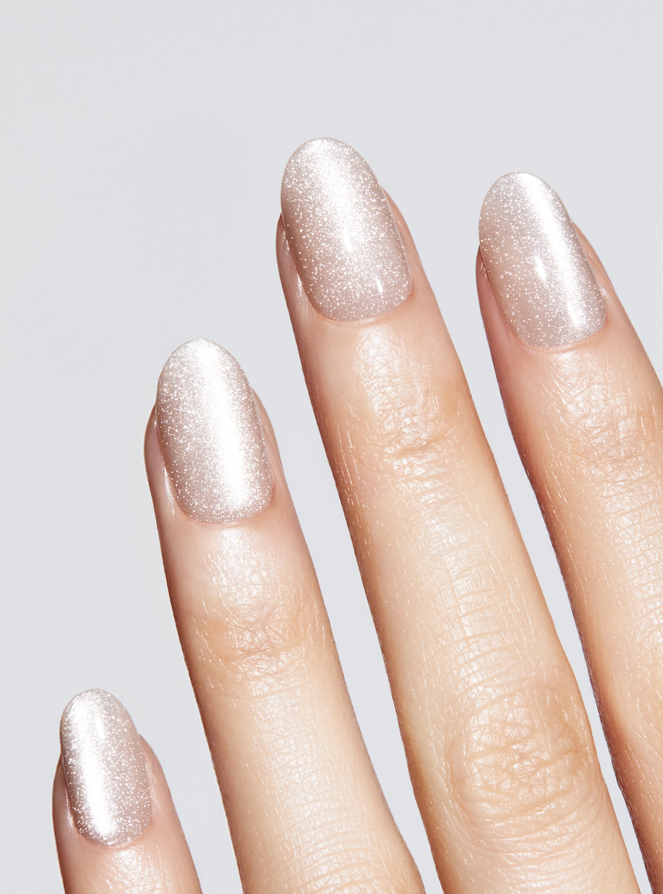 Nude manicure with cat-eye effect in round shape,