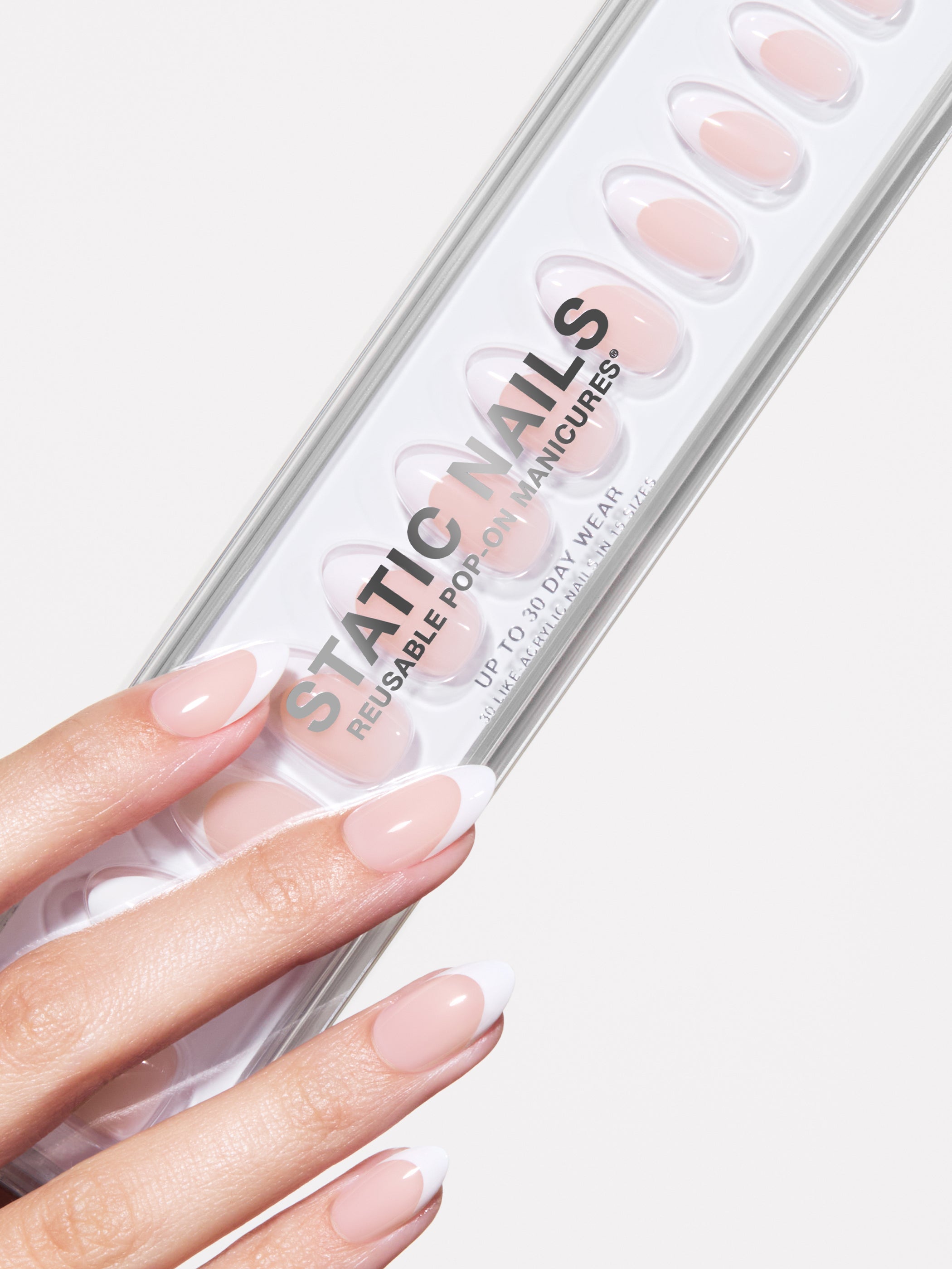 Hand holding a pack of Static Nails reusable powder manicures on a white background