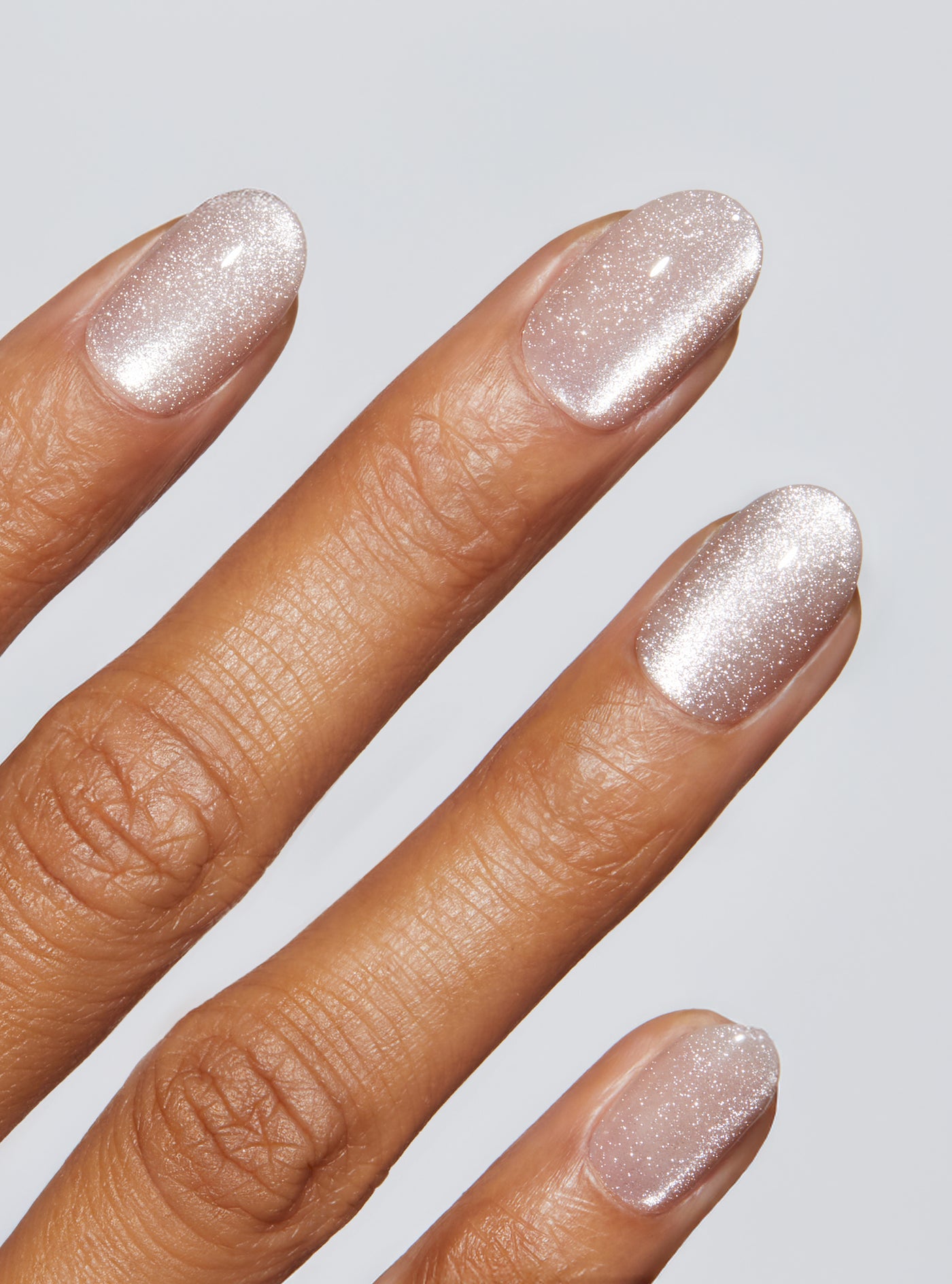 Nude manicure with cat-eye effect in round shape,