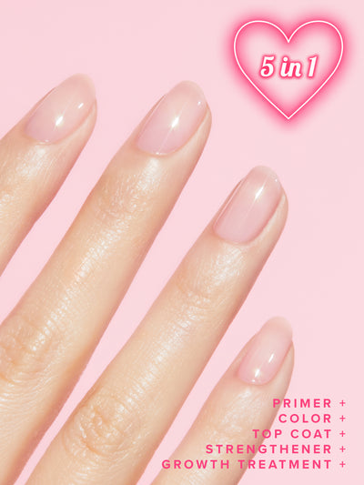 SIGNATURE PINK 5-IN-1 RAPID GROWTH NAIL TREATMENTHand with pink nail polish on a pink background