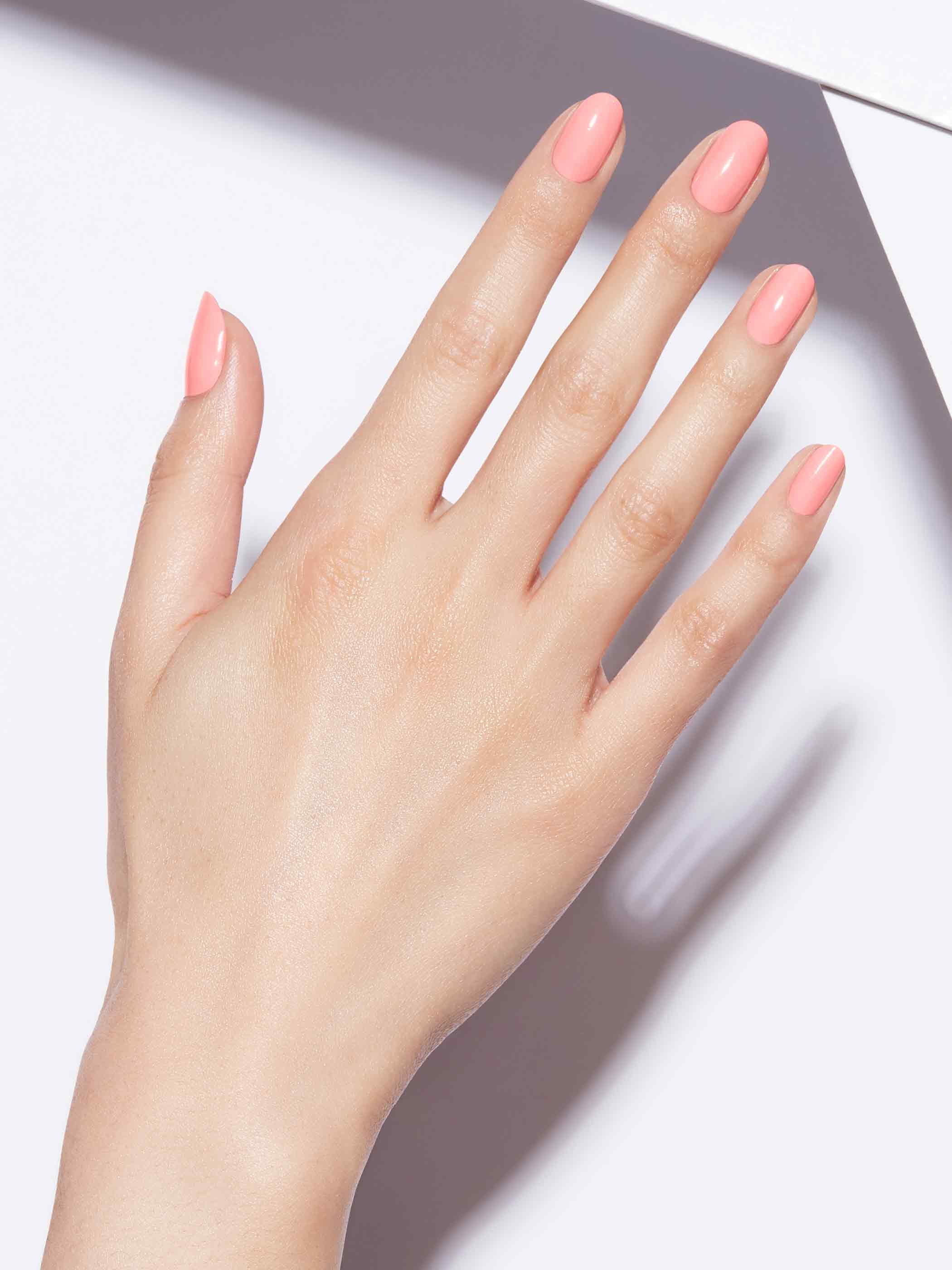 Neon pastel orange full-coverage nail polish, Light