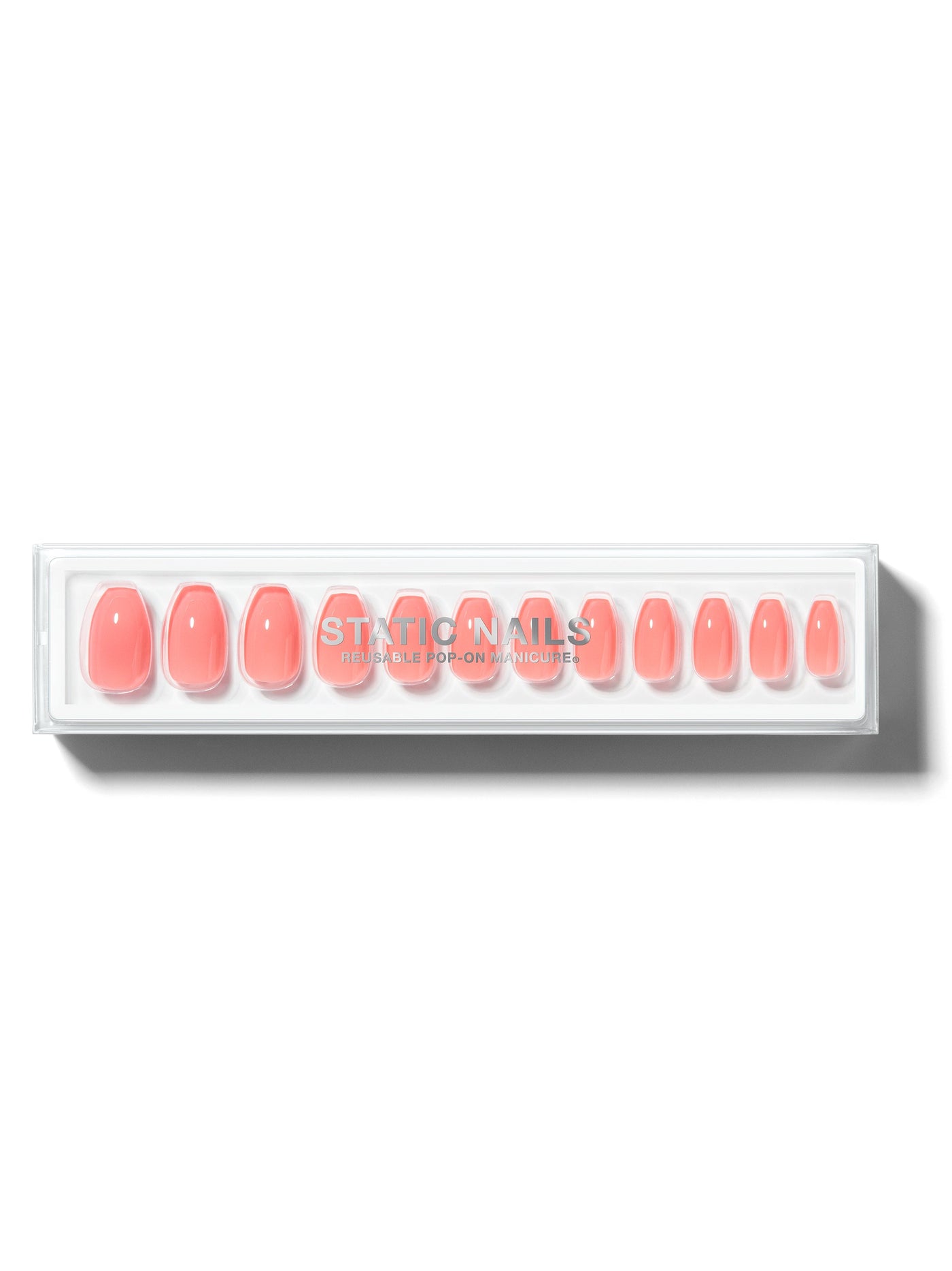 Orangey-pink manicure in coffin shape,