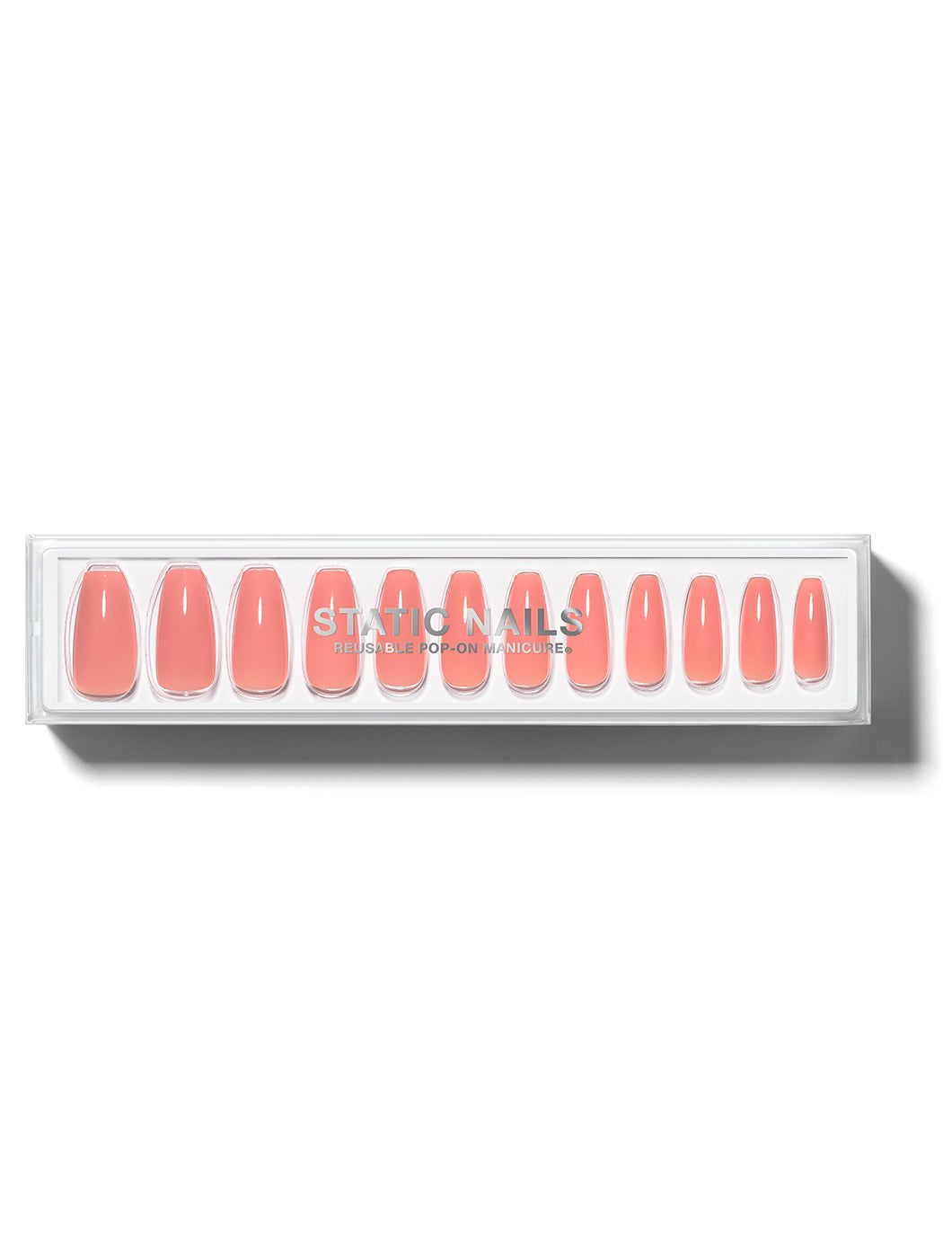 Orangey-pink manicure in long coffin shape,