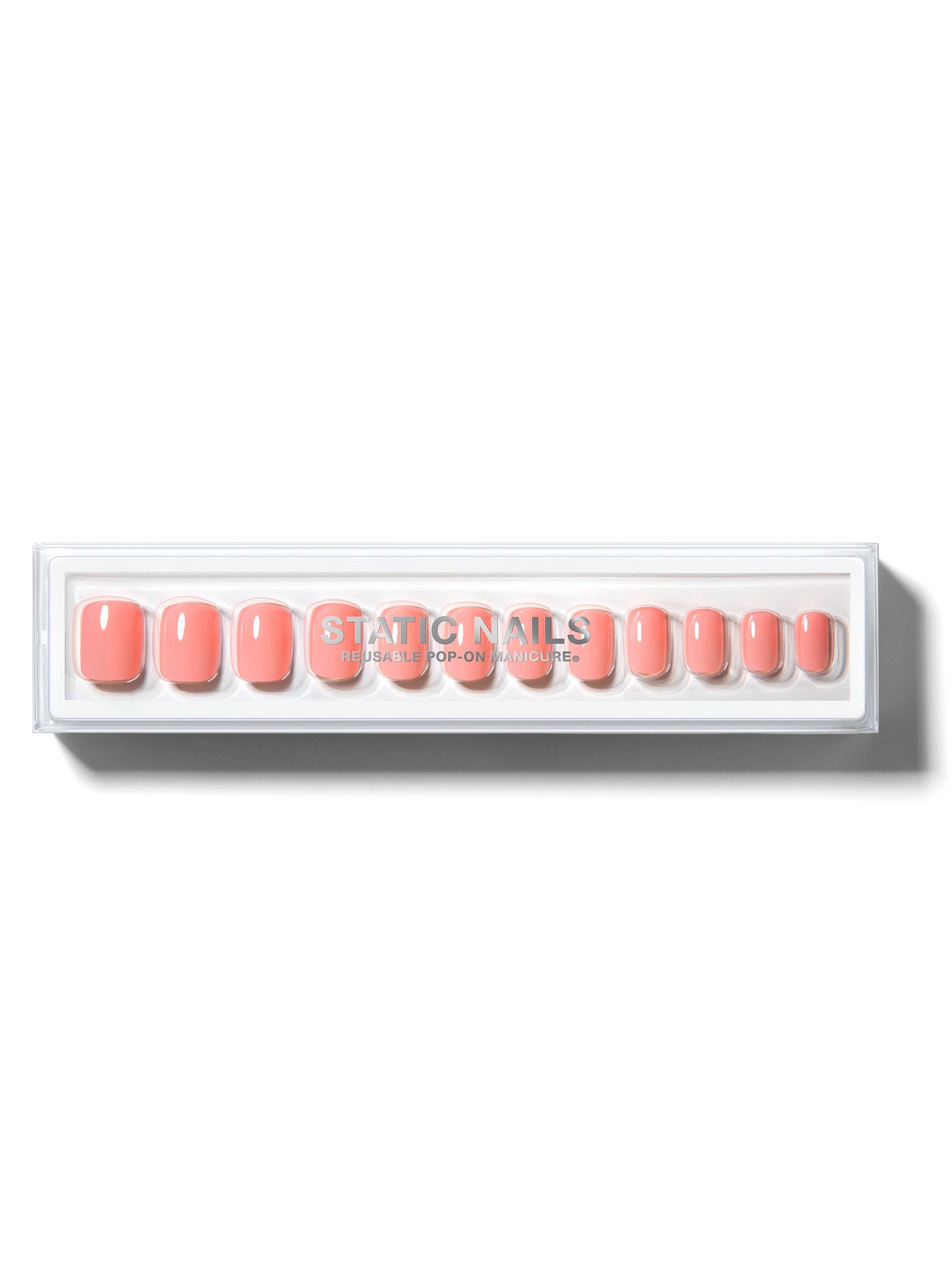 Orangey-pink manicure in short square shape,