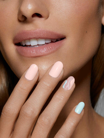 Pale pink and powder blue manicure with pink and blue swirl accent nails in round shape,