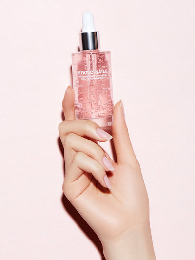 Bottle of pink rose scented nail polish and pop-on nail remover